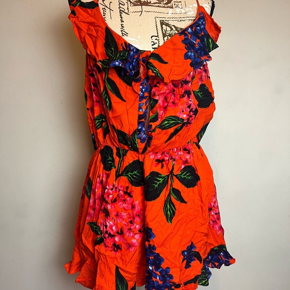 Bright Orange Floral Romper with Ruffled Details
